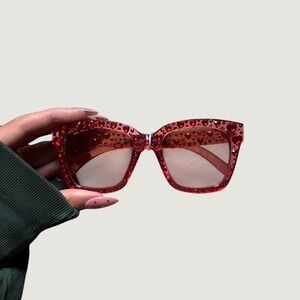 Red glitter sunglasses with heart-shaped embellishments